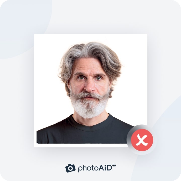 An example of a passport photo with a mustache casting a shadow on the face.