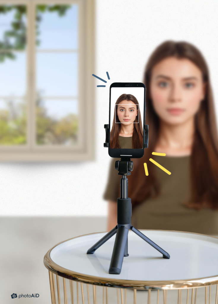 Setting up an iPhone on a tripod to take a passport photo.