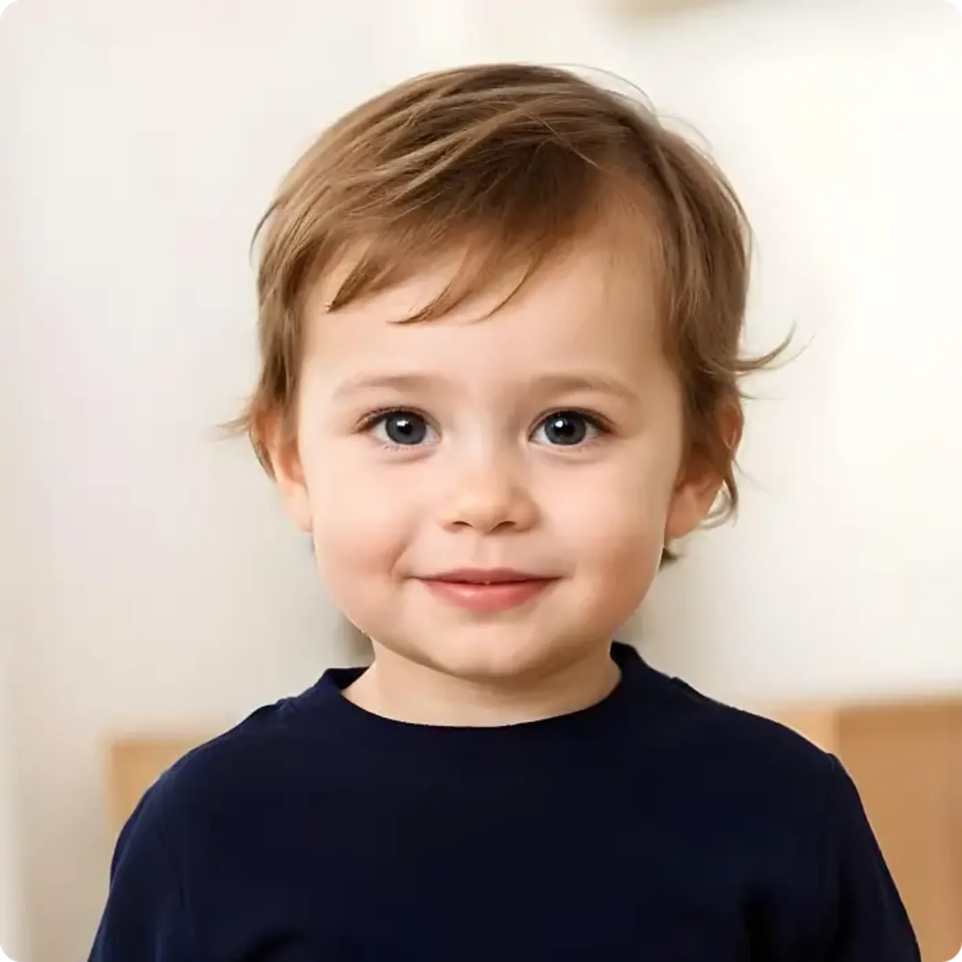 Baby smiling gently (with mouth closed) in a passport picture.