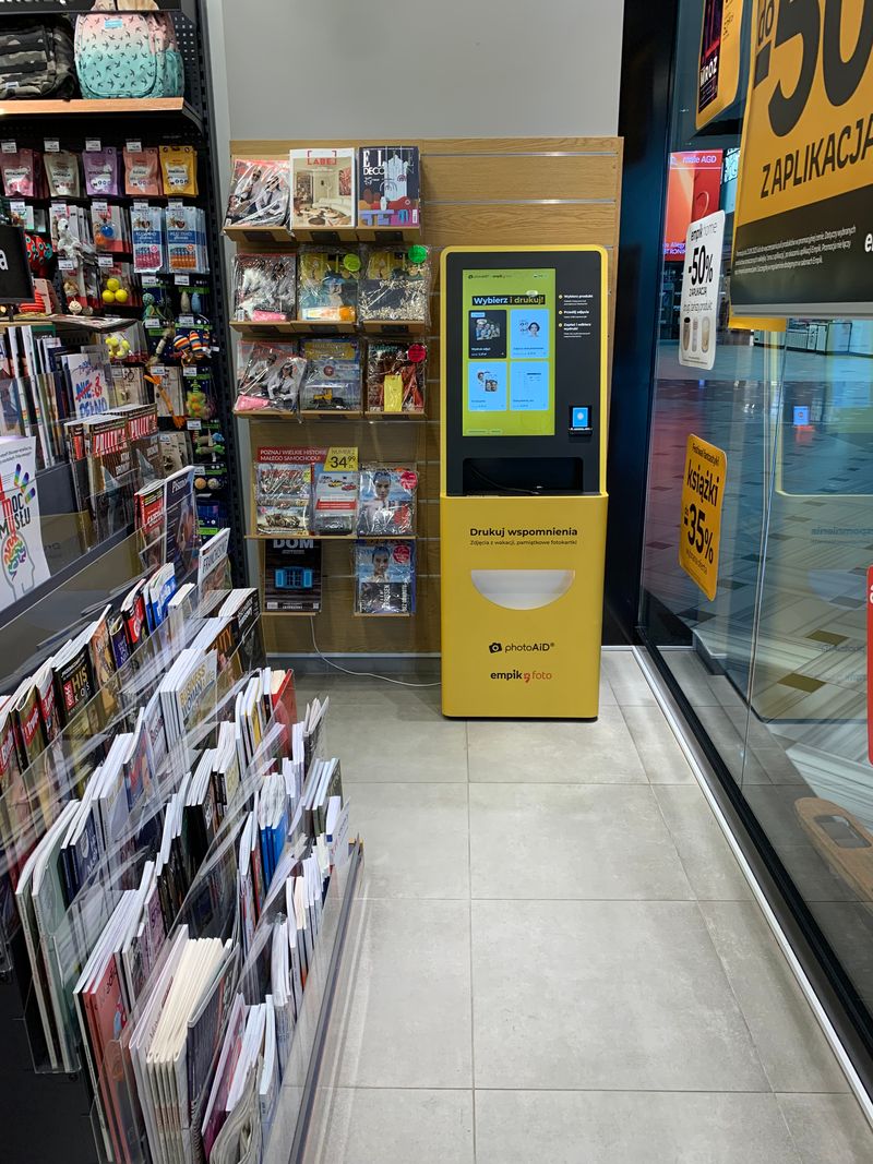 Żółto-czarny foto kiosk PhotoAiD do wydruku zdjęć i dokumentów w Empik Atrium Promenada