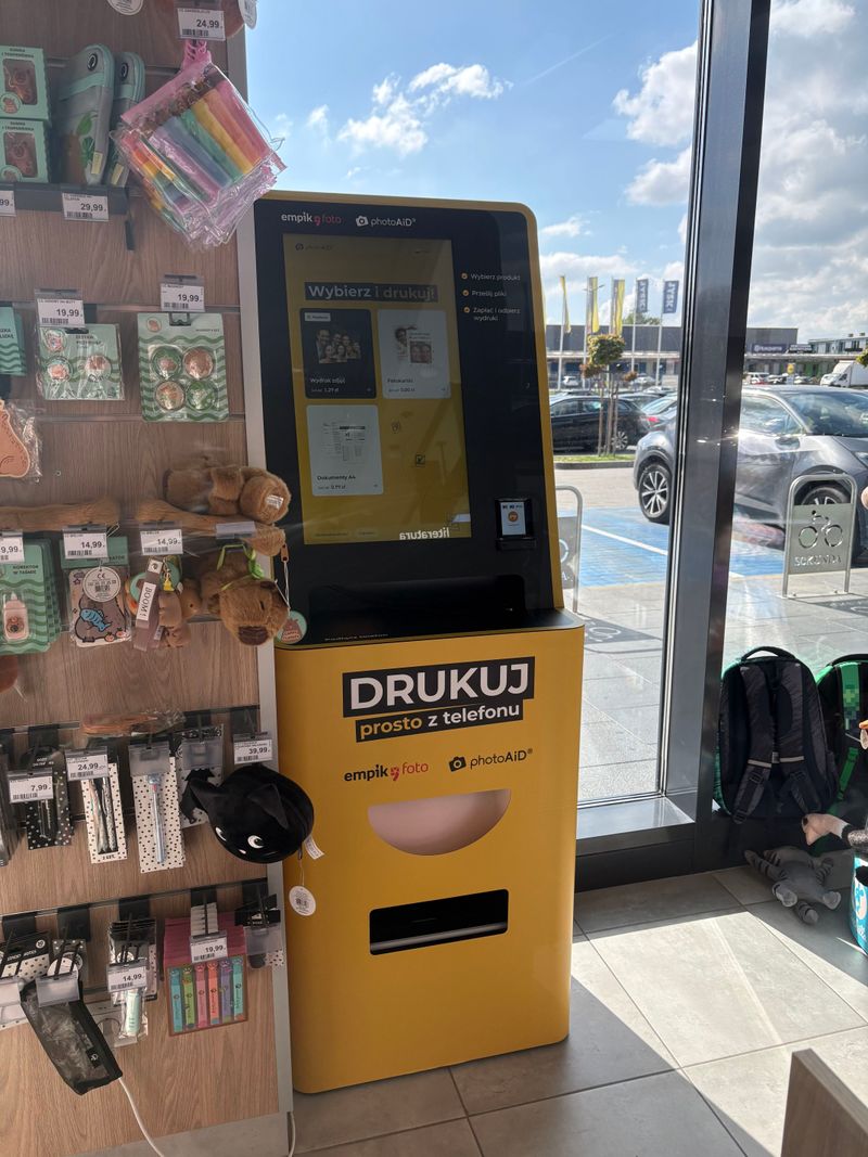 Żółto-czarny foto kiosk PhotoAiD do wydruku zdjęć i dokumentów w Empik Galeria Sekunda