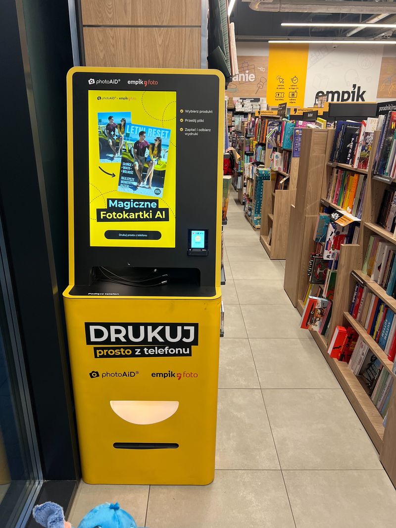Żółto-czarny foto kiosk PhotoAiD do wydruku zdjęć i dokumentów w Empik Wrocław Średzka